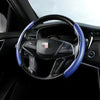 A black steering wheel with blue stitching and a carbon fiber trim is shown inside a car interior.