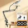 Black adjustable phone stand with overhead light illuminating a baked good on a wooden table