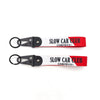 Red and white nylon keychain with a steel clip featuring the text SLOW CAR CLUB in English and Japanese