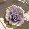 A purple lotus flower silicone mold with gold accents, shown in a close-up on a white surface.