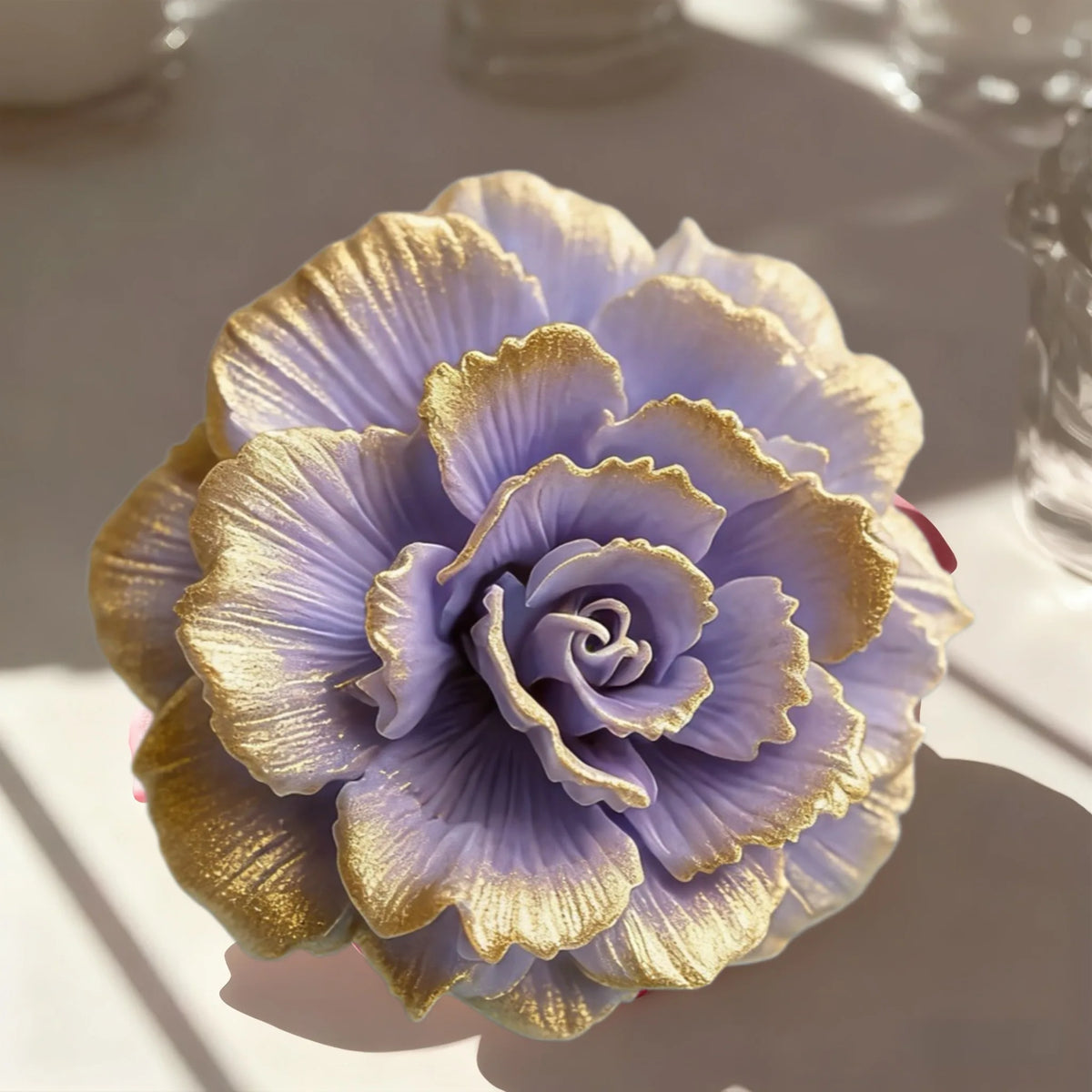 A purple lotus flower silicone mold with gold accents, shown in a close-up on a white surface.