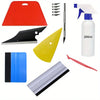 A collection of professional car window tinting tools including a red applicator, various blades, and a white bottle.