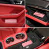 Red interior of a car showing a slim card holder wallet for vehicle registration, license, and insurance cards.