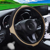 Interior view of a car showing a black steering wheel with tan leather accents and diamond stitching.