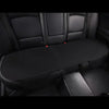 A black car seat cushion with a textured surface is shown inside a vehicle cabin.
