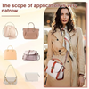 A woman models a beige leather mini bag with a strap set and alloy buckles, worn over a tan coat.