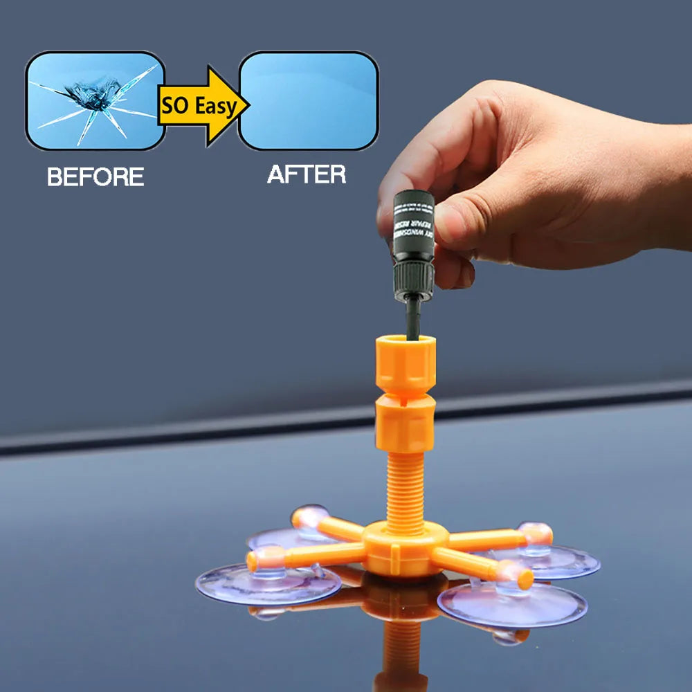 A hand holds a syringe applicator used to apply a DIY windshield repair kit onto a surface.