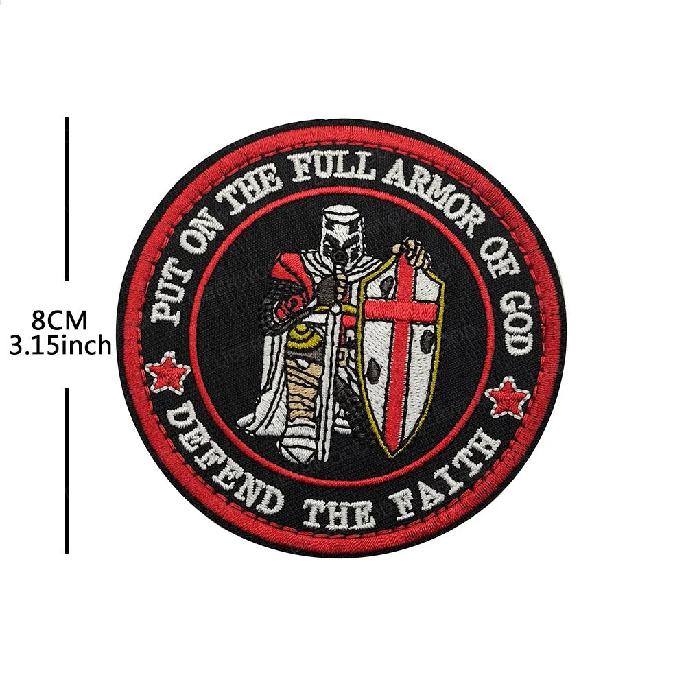 Red embroidered patch featuring a knight's helmet and shield with text that reads Put on the full armor of God defend the fai