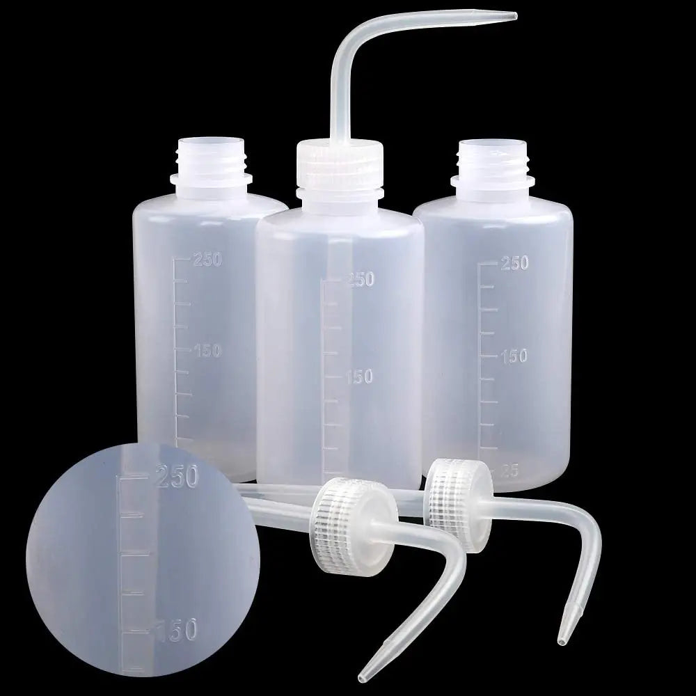Clear plastic tattoo squeeze bottles with precision tips and a measuring device