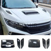 Black decorative hood scoop covers and air intake vents for a vehicle.