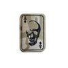 An embroidered patch featuring a skull design with an ace of spades and hook and loop backing.