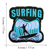 Black and blue embroidered patch featuring the word SURFING above a stylized sea wave and surfboard.