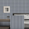 A close-up of vertical gray slat wall panels used as a headboard or decorative partition in a modern bedroom setting.