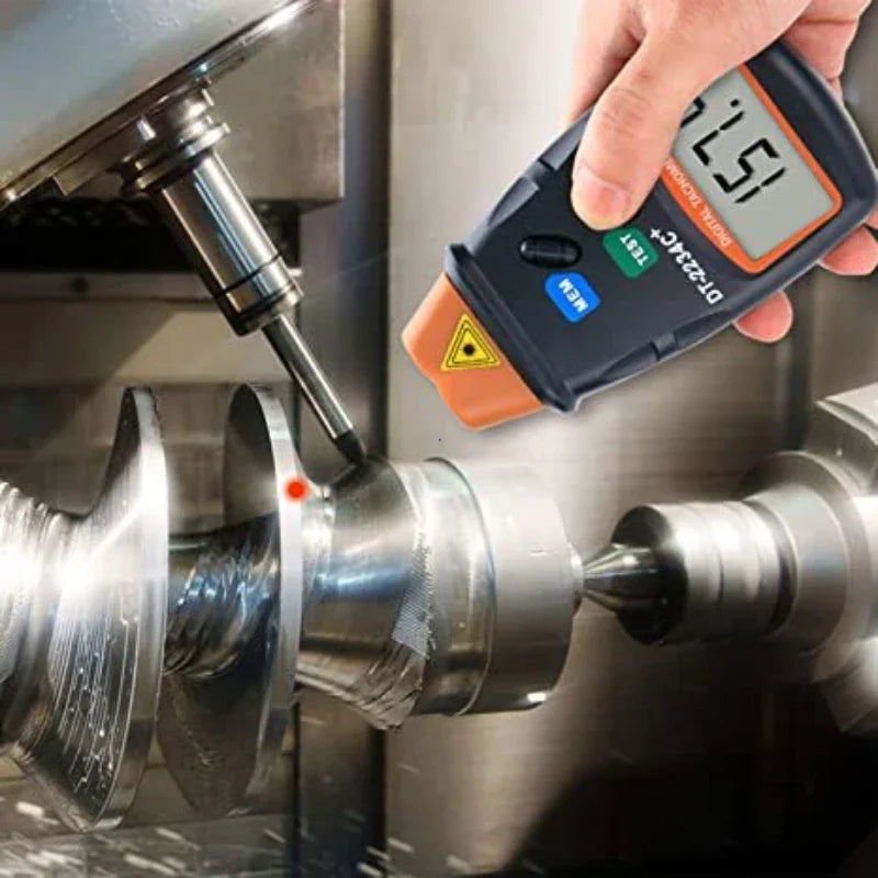 A hand holds a digital laser tachometer measuring 151.7 RPM on a metal shaft.