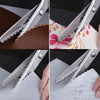 Stainless steel pinking shears being used to cut fabric and craft materials.