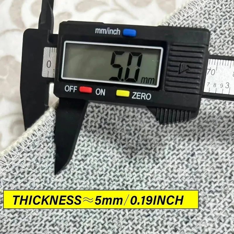 A black digital caliper measures the thickness of a fabric, displaying 5.0 mm or 0.19 inch.