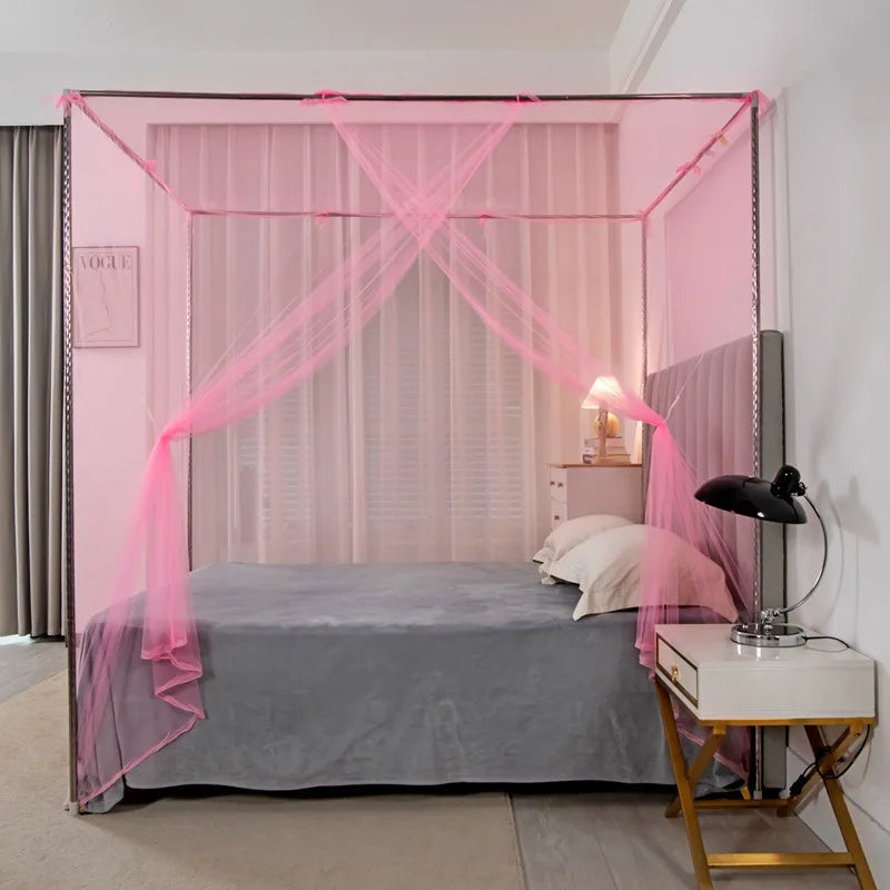 A pink lace canopy mosquito net draped over a bed in a bedroom setting.