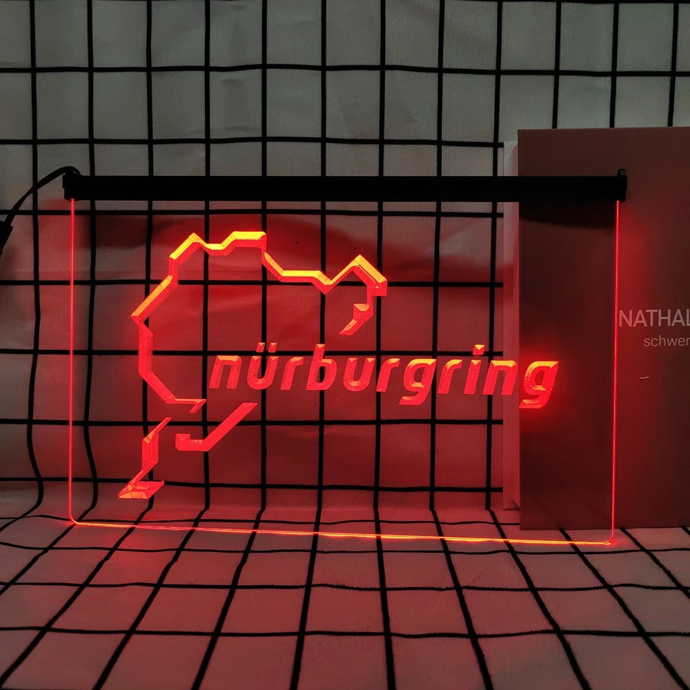 A neon sign shaped like the map of Nuremberg in bright red light displayed against a black grid background.
