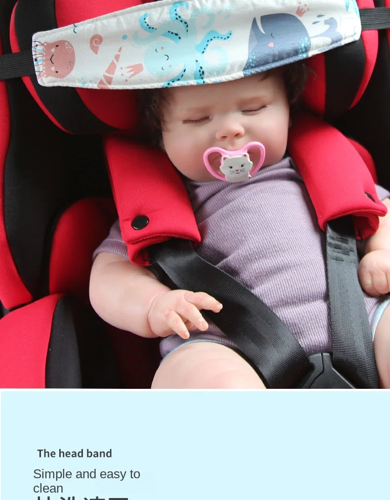 A baby is secured in a red car seat with a head band and safety strap.