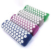 A set of five rolled acupressure mats in various colors including green, purple, and blue.
