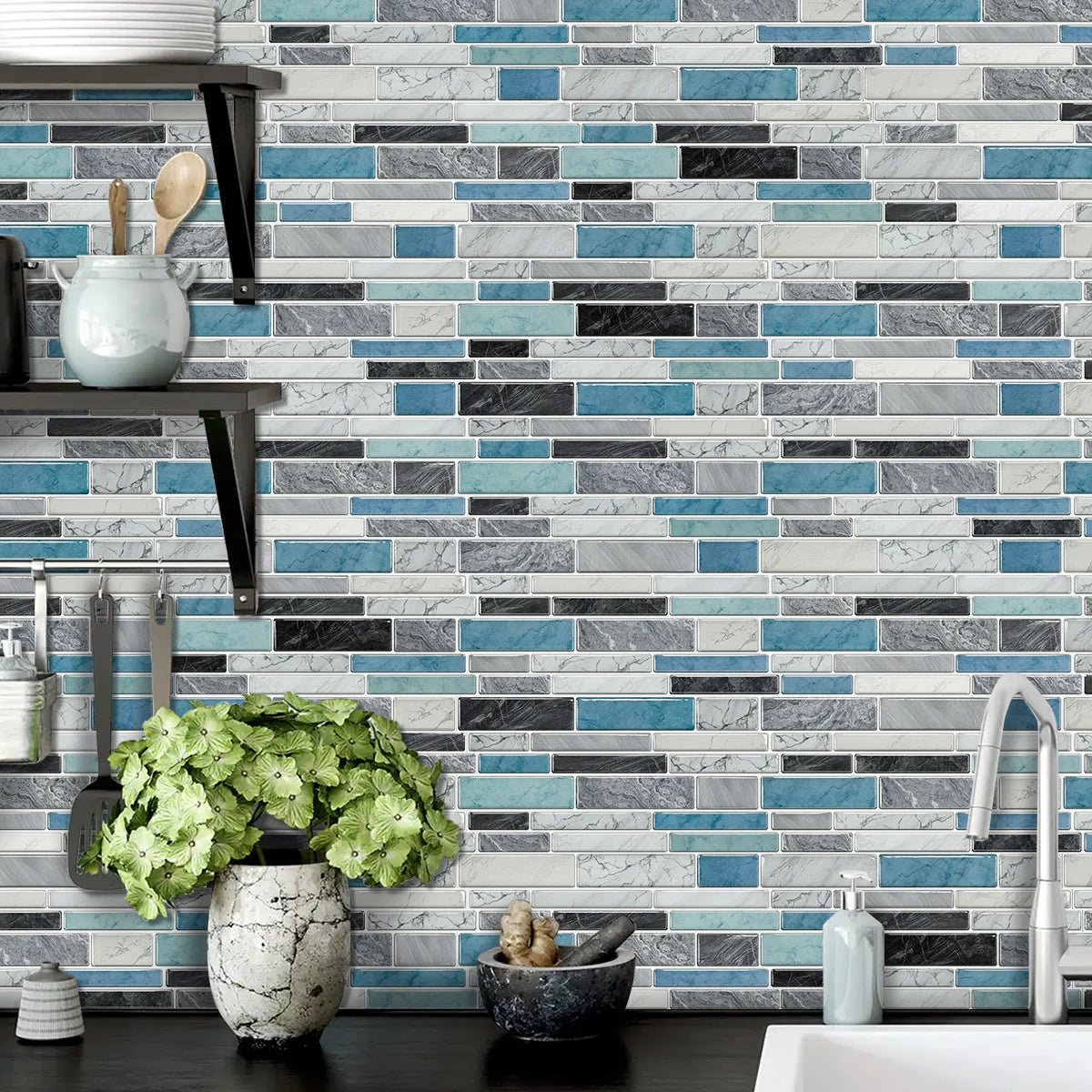 A gray and blue subway tile backsplash featuring various rectangular tiles in shades of light gray, dark gray, and teal.