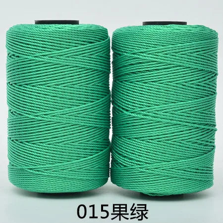 Spool of 3-ply green polyester knitting yarn for crochet and hand crafts