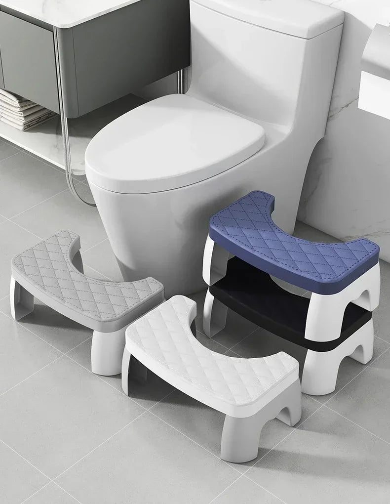 A white toilet squat stool with a blue seat and a black seat, shown next to a modern toilet.