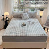 A gray rabbit fur fleece fitted sheet and pillowcase set displayed on a bed with natural light.