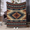 A patterned flannel throw blanket featuring geometric designs in brown, navy blue, and beige tones.