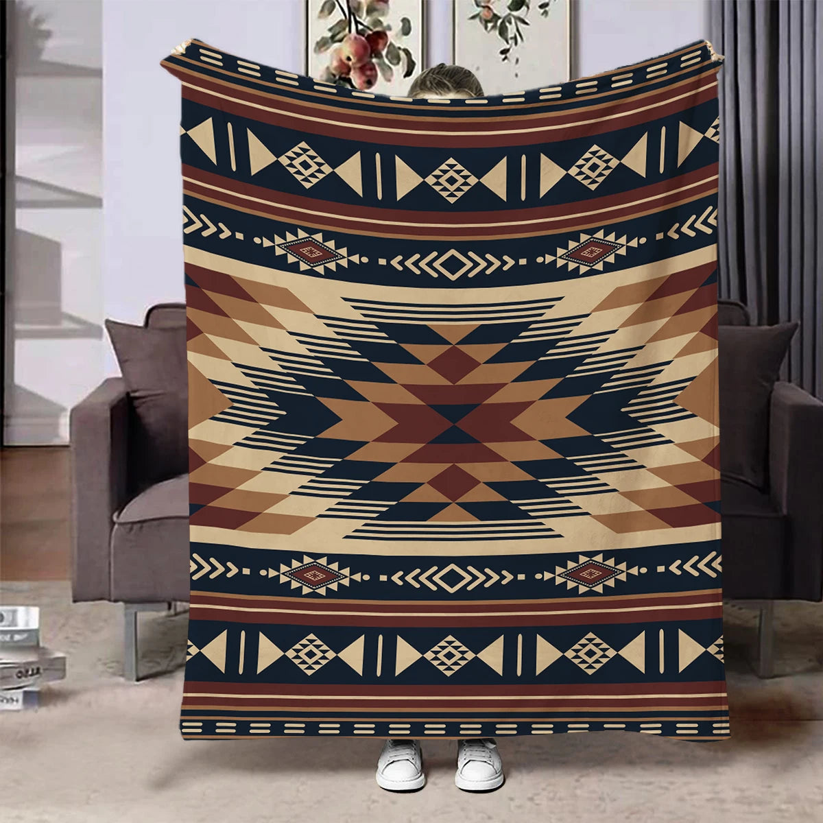 A patterned flannel throw blanket featuring geometric designs in brown, navy blue, and beige tones.
