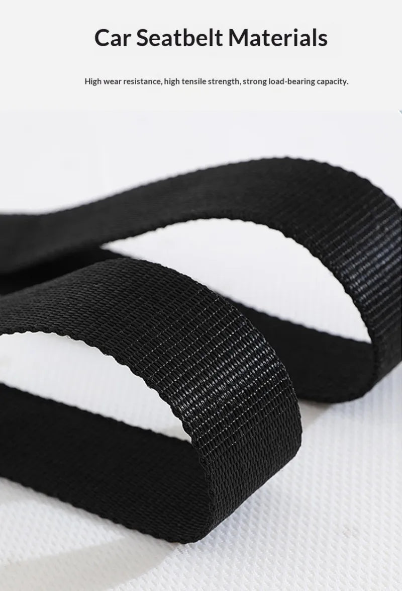 A close-up view of a black car seatbelt material showing its woven texture and strap design.