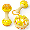 A set of yellow and orange baby sensory spinning rattle toys with a handle and a ring.