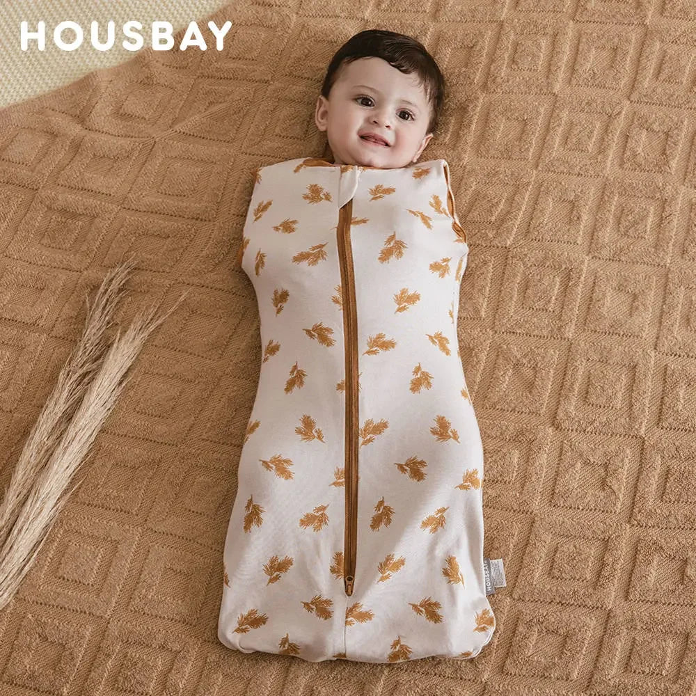 A baby wearing a beige breathable cotton sleep sack with a subtle floral pattern, lying on a woven fabric background.