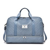A light blue nylon travel duffle bag with handles and a zippered closure.