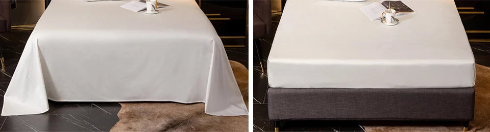 Luxuriöses Bambus-Bettwäsche-Set auf einem Tisch mit weißen Laken und Dekorationen.