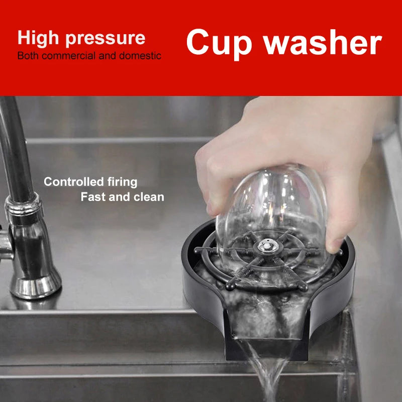 A hand is using a high pressure cup washer to clean a glass in a commercial or domestic setting.