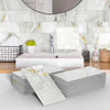 Stacks of white marble self-adhesive wall stickers used as 3D tile decals in a bathroom setting.
