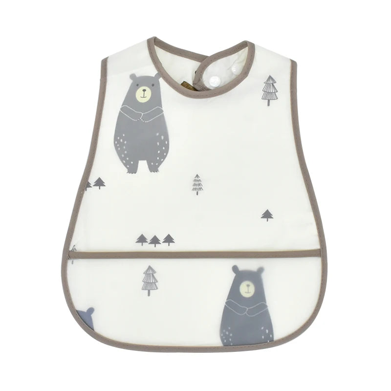 A white baby feeding bib with a gray bear design and a catch pocket, featuring a brown trim.