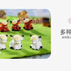 Three resin figurines of Highland cows in various colors, including orange and white, displayed on green grass.