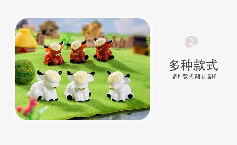 Three resin figurines of Highland cows in various colors, including orange and white, displayed on green grass.