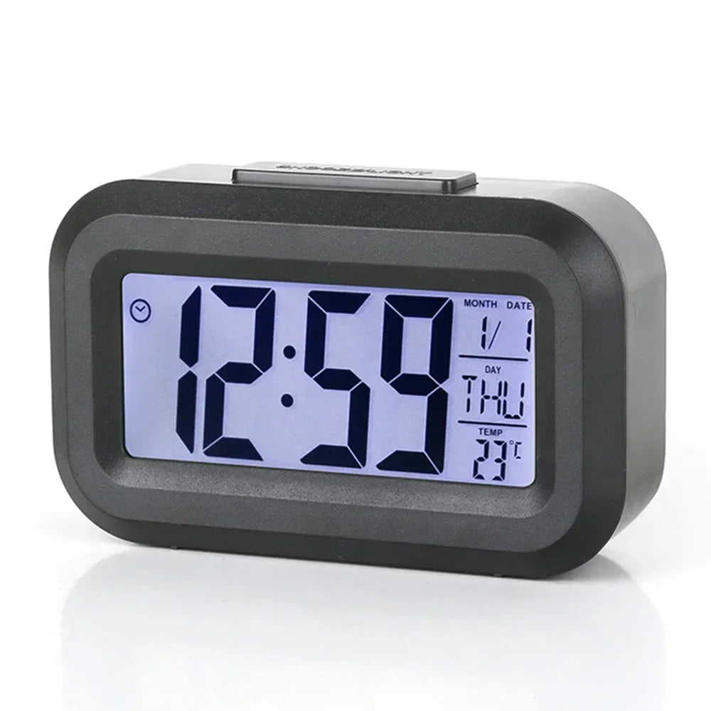 A black compact LED digital alarm clock displaying 12:59, with a display showing the date and temperature.