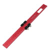 Red aluminum pocket ruler with a T-track slide stop and a rectangular plastic holder.