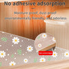 A beige kitchen drawer mat with a white daisy flower pattern is shown on a wooden surface.