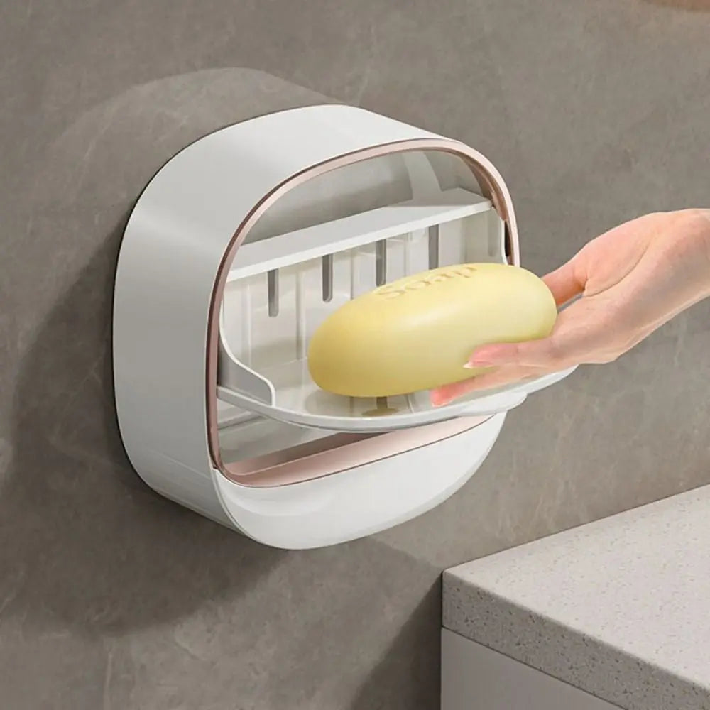 A hand is placing a yellow soap dish into a wall-mounted drainage rack.