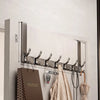 A modern silver over-the-door organizer rack with eight hooks mounted on a light gray wooden panel.
