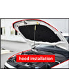 Hood installation of a white car showing the interior and engine compartment.