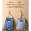 Two wall-mounted fabric garbage bags in blue and gray hanging on a beige wall.