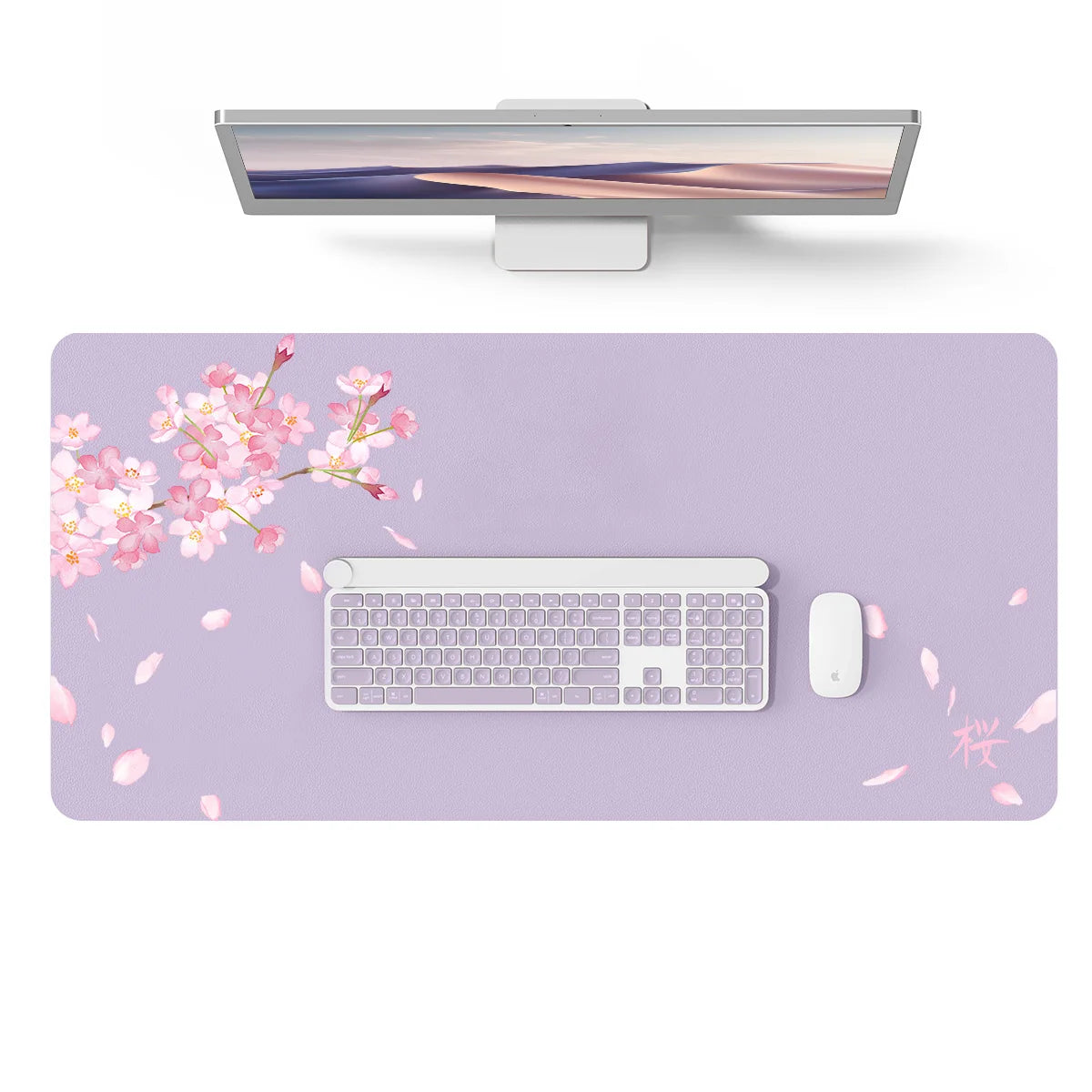 A silver laptop is displayed above a purple desk pad featuring pink cherry blossoms and a white wireless mouse.