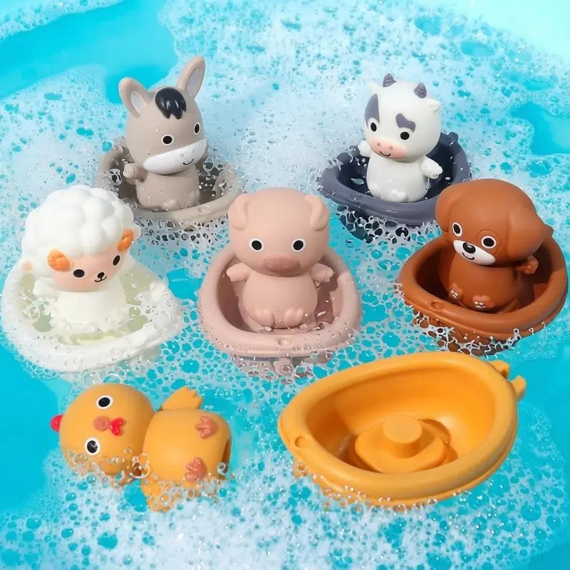 A collection of silicone animal finger puppets and bath toys floating in clear water.