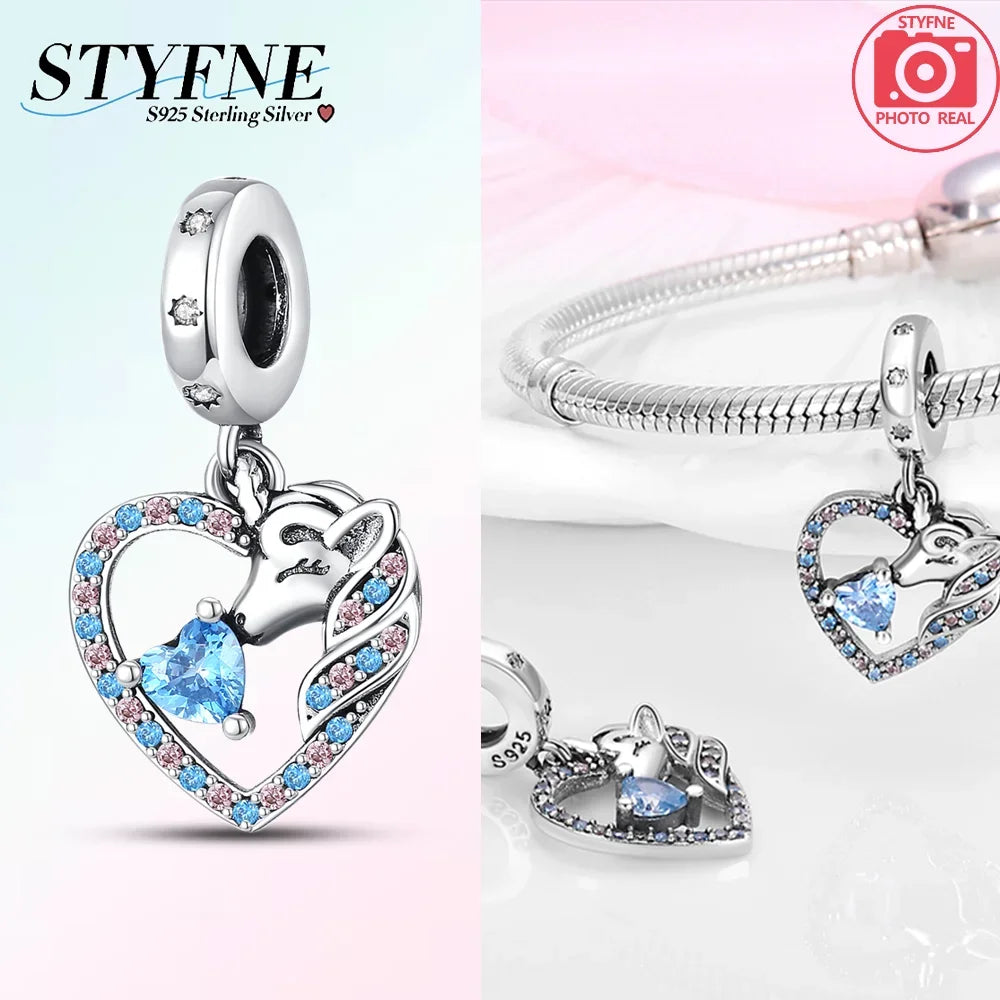 Silver pendant necklace featuring a unicorn and pegasus design with sparkling blue and pink crystals.